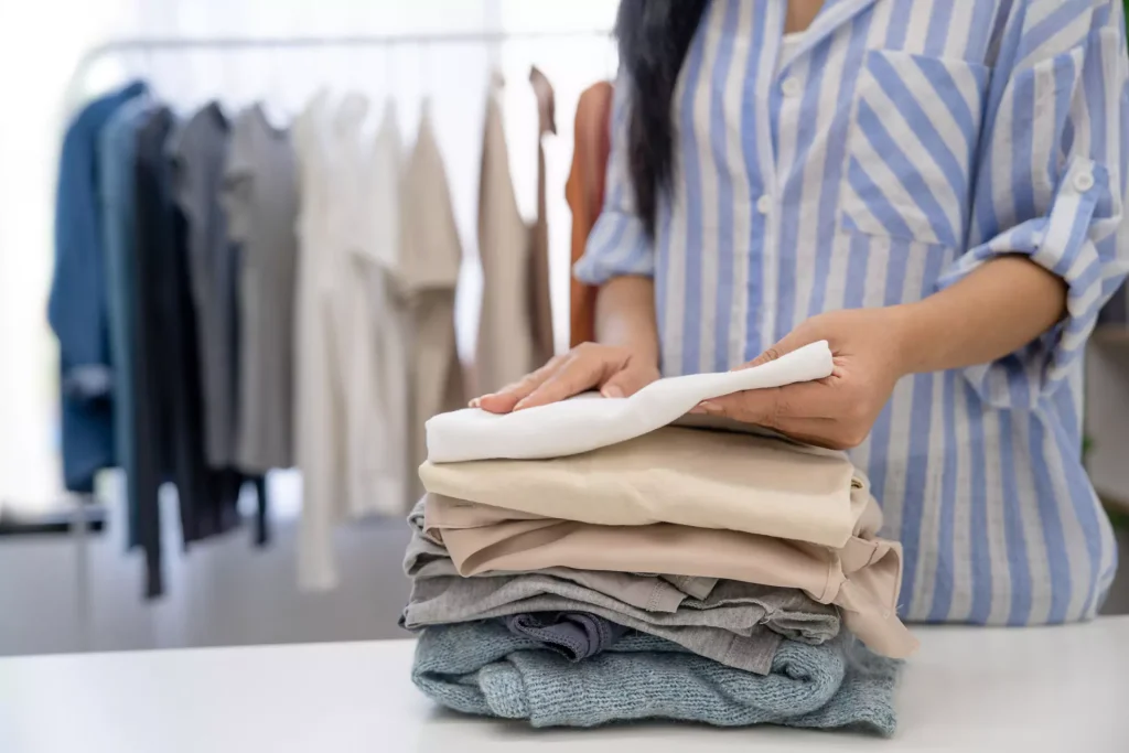 Folding clean laundry on table